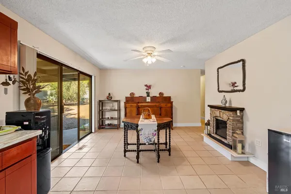 a dining room with furniture and chandelier fan