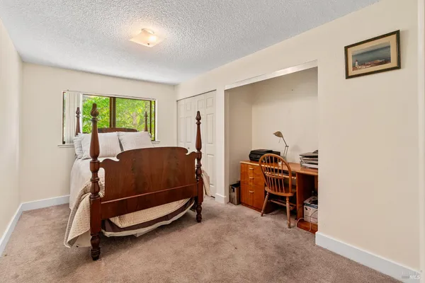a bedroom with a bunk bed and a window