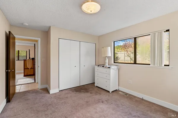 an empty room with windows and closet