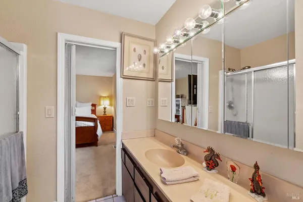 a en suite bathroom with a tub sink and mirror
