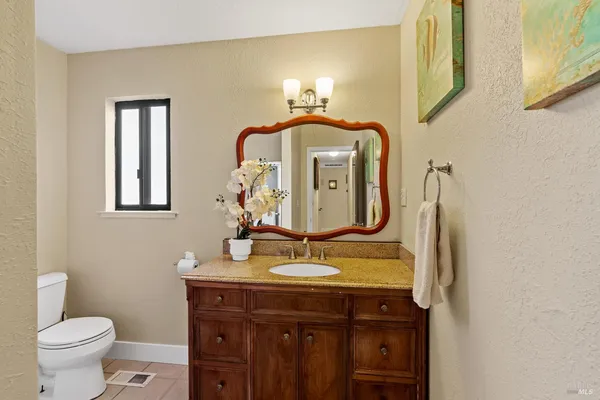 a bathroom with a toilet sink and mirror