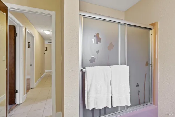 a bathroom with a shower and a sink