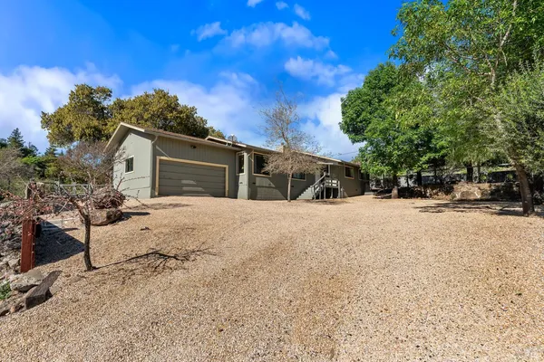 a view of a house with a yard covered with snow in the background
