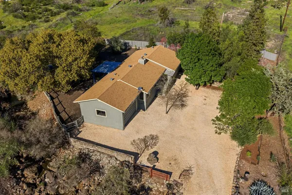 an aerial view of a house with a yard