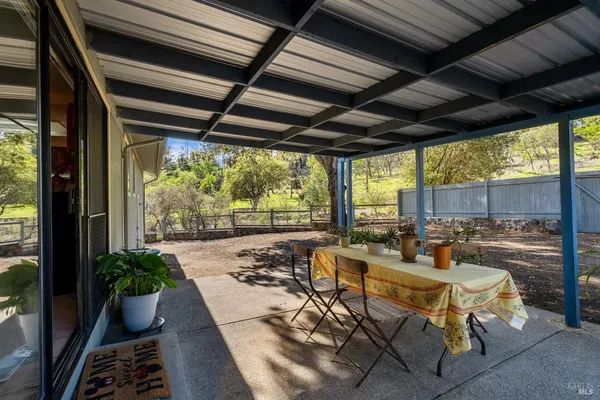 a view of a patio with table and chairs and potted plants