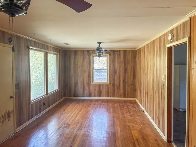wooden floor in an empty room with a window