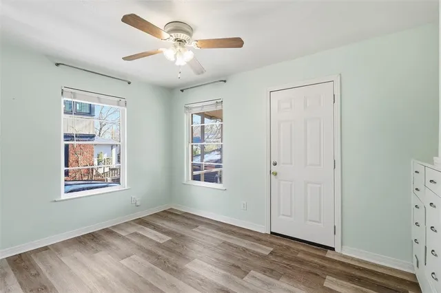 a view of an empty room with a window and closet