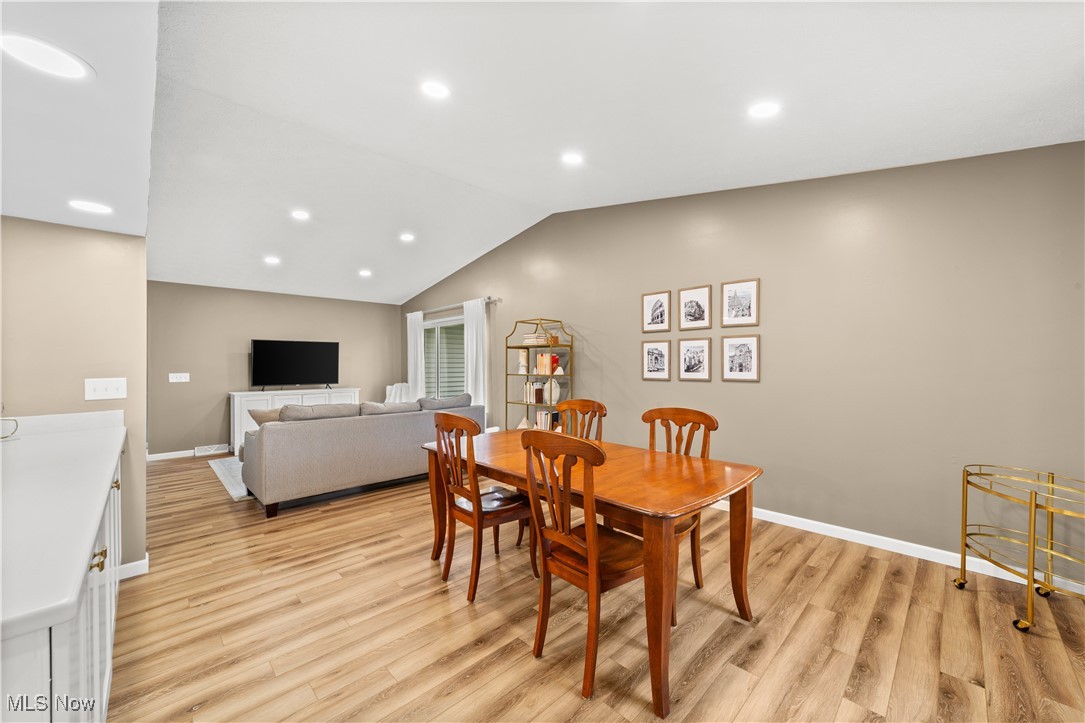 2977 Reeves Road Willoughby, OH 44094 - Photo 17 of 49 Dining area with LVP floors, recessed lighting, vaulted ceiling, and baseboards