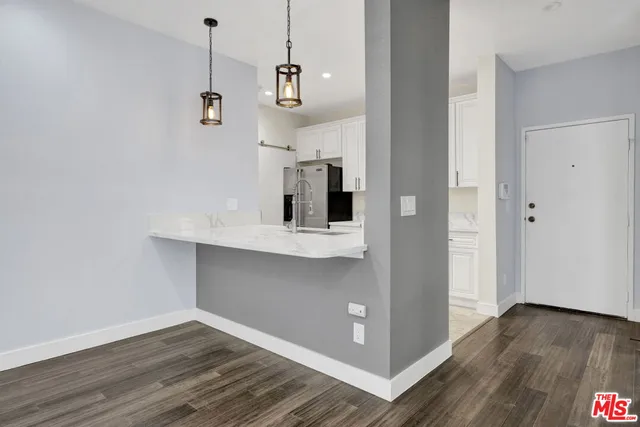 a view of a room with wooden floor and cabinet