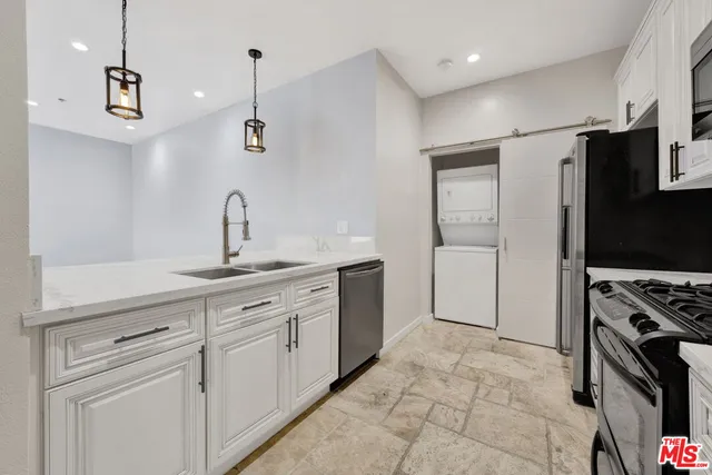 a kitchen with a sink appliances and cabinets