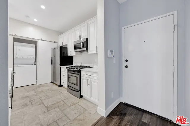 a kitchen with stainless steel appliances a refrigerator and a stove top oven