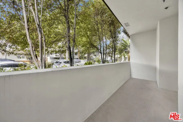 a view of a large window with tree in the background