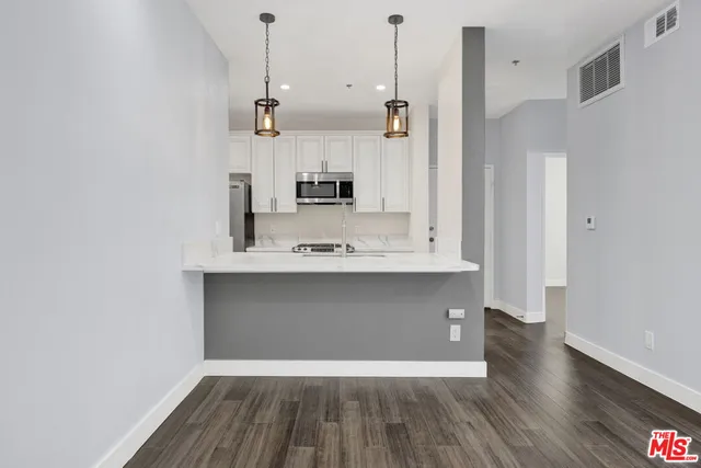 a view of kitchen and wooden floor