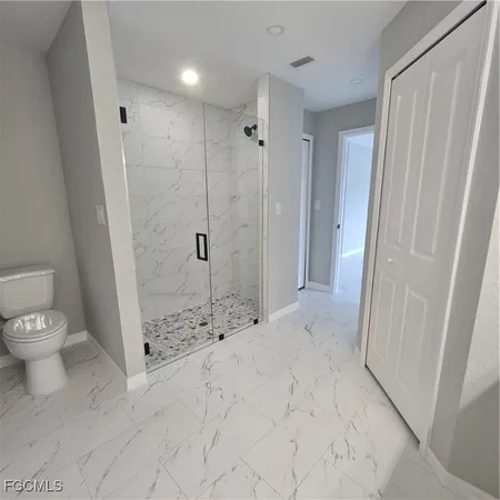 a bathroom with double vanity and a mirror