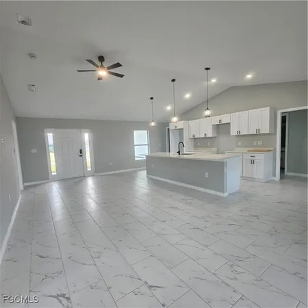 a view of a kitchen with furniture and chandelier