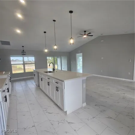 a large white kitchen with lots of counter space