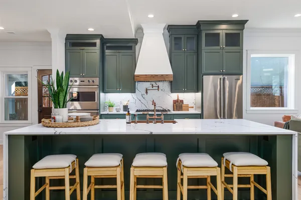 a kitchen with stainless steel appliances a sink and cabinets