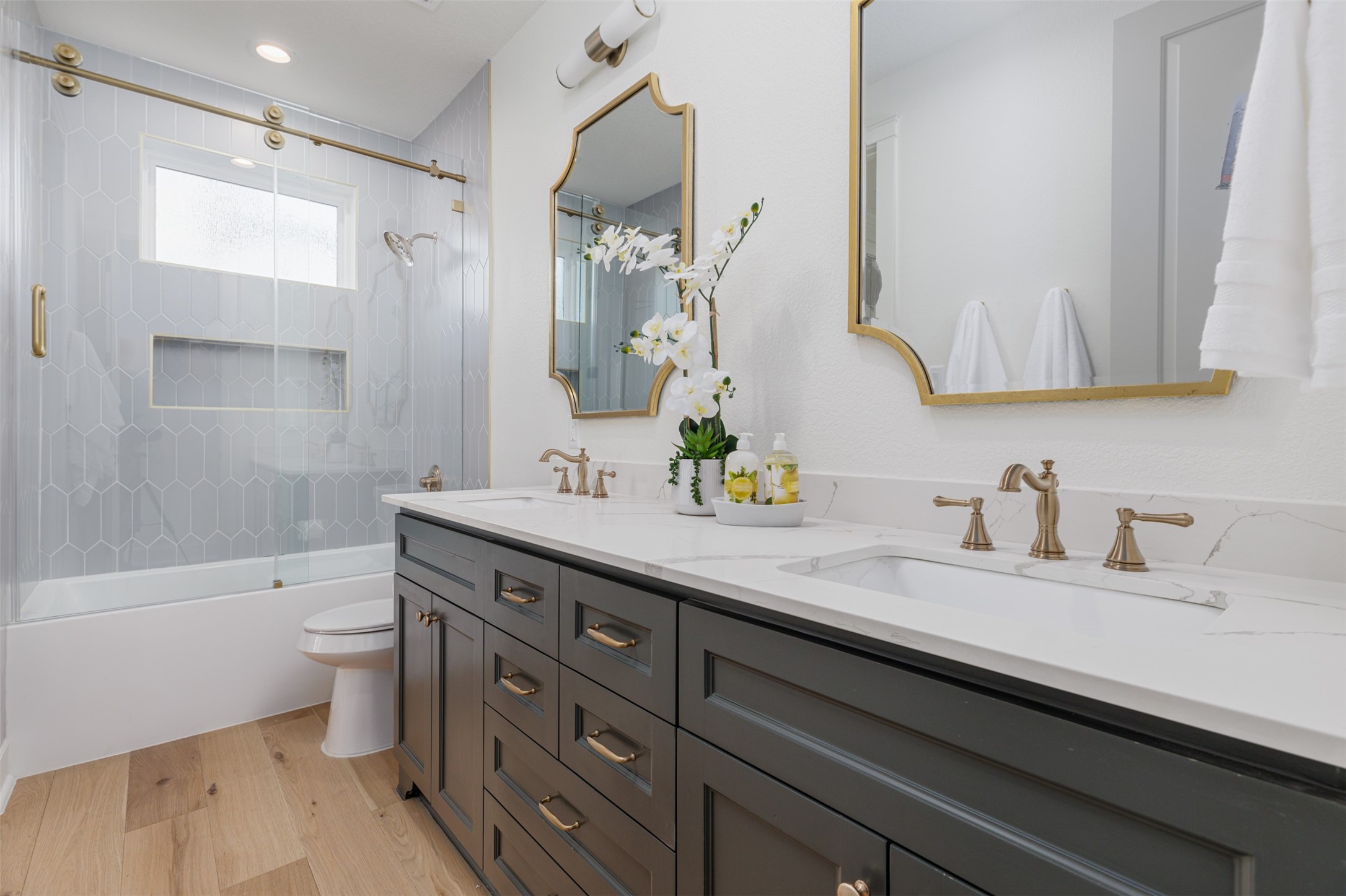 1535 Rutland Street Houston, TX 77008 - Photo 33 of 50 a bathroom with a granite countertop sink a toilet a mirror and shower