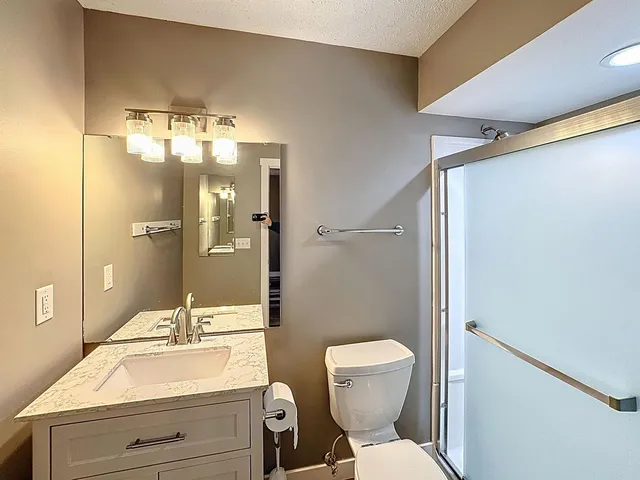 a bathroom with a sink toilet and shower