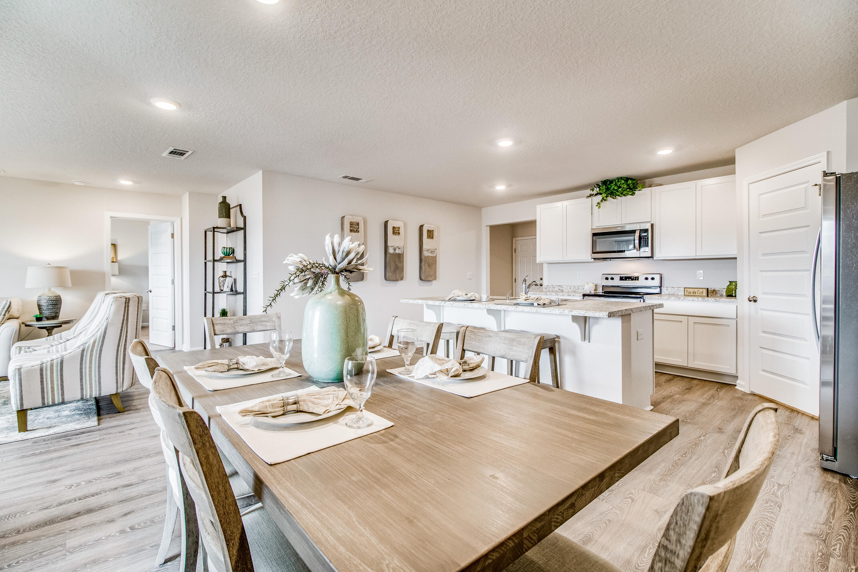 6324 Firefly Drive Milton, FL 32583 - Photo 11 of 32 a kitchen with kitchen island a stove a table and chairs