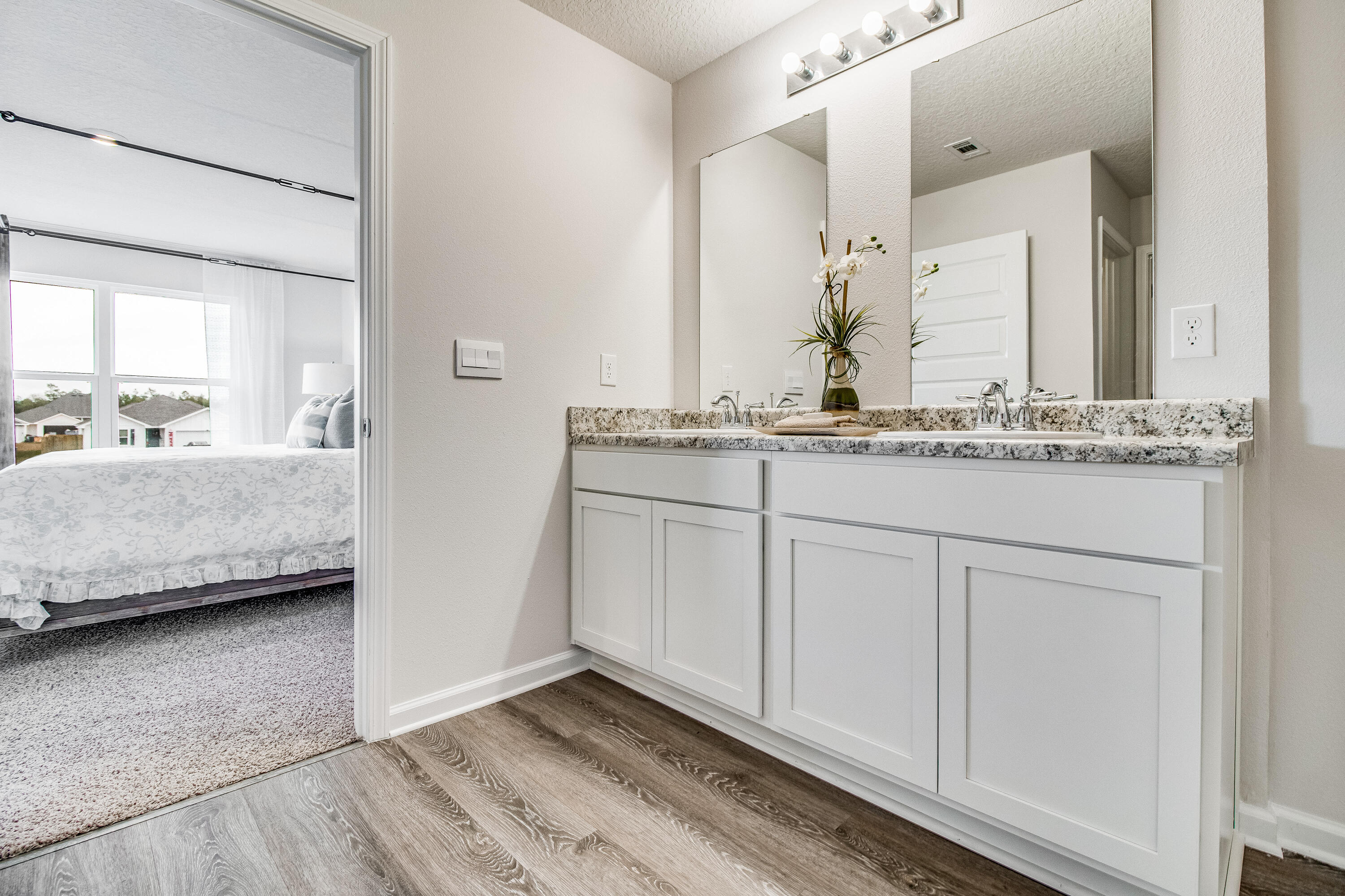 6324 Firefly Drive Milton, FL 32583 - Photo 15 of 32 a en suite bathroom with double sink and a mirror