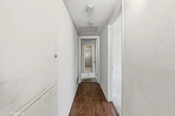 a view of a hallway with wooden floor and a hallway