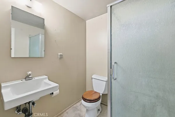 a bathroom with a sink toilet and a mirror