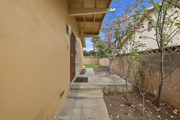 a view of a pathway of a house with a yard