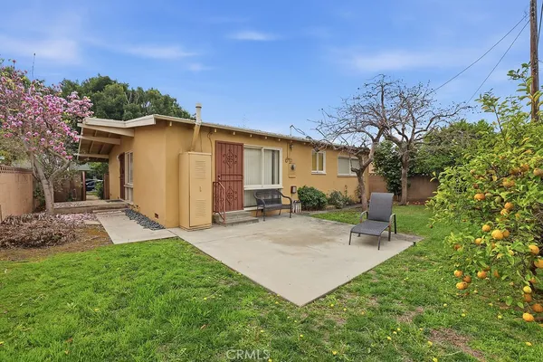 a view of a backyard with plants and a patio