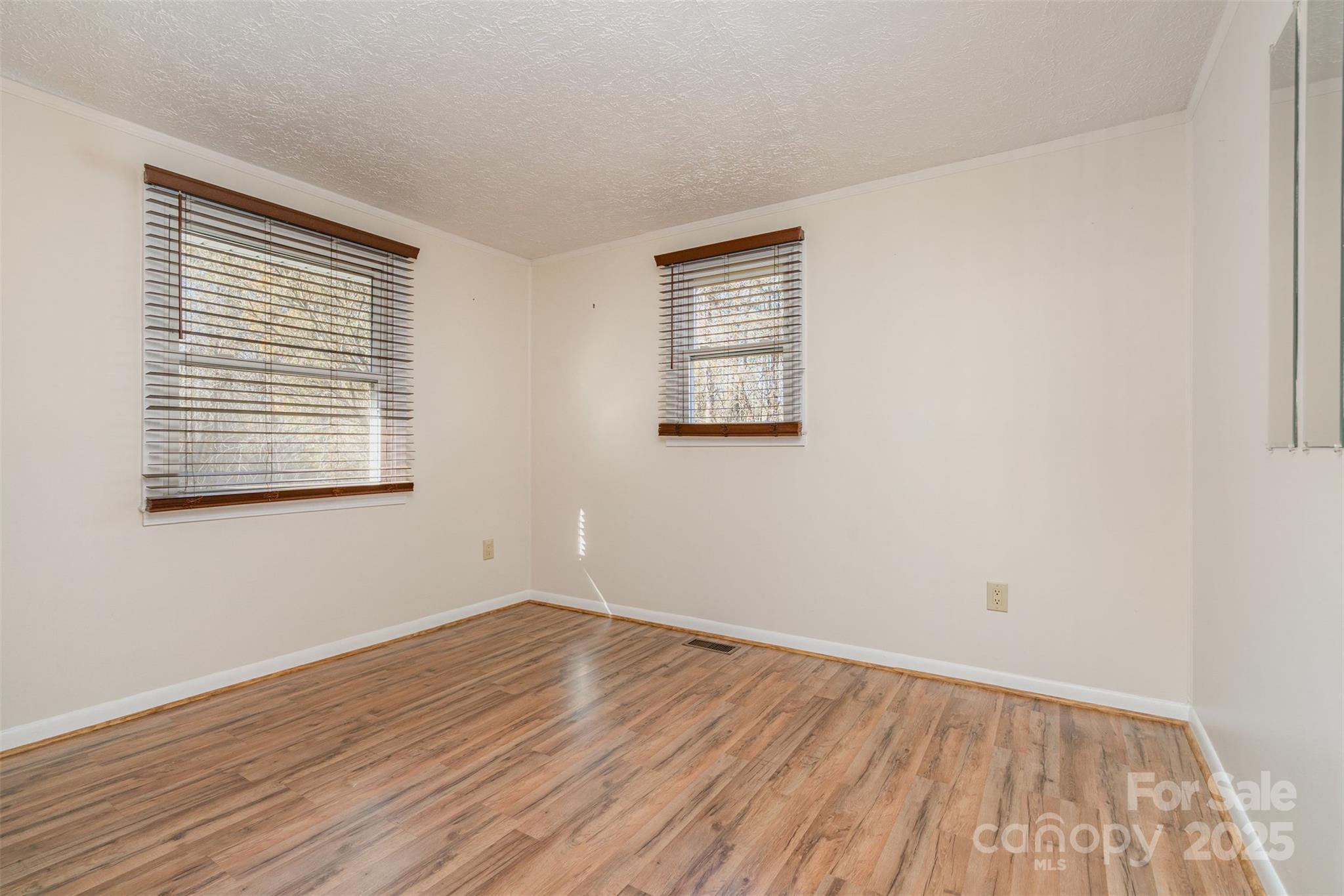650 Rama Wood Drive Southeast Concord, NC 28025 - Photo 11 of 17 wooden floor in an empty room with a window