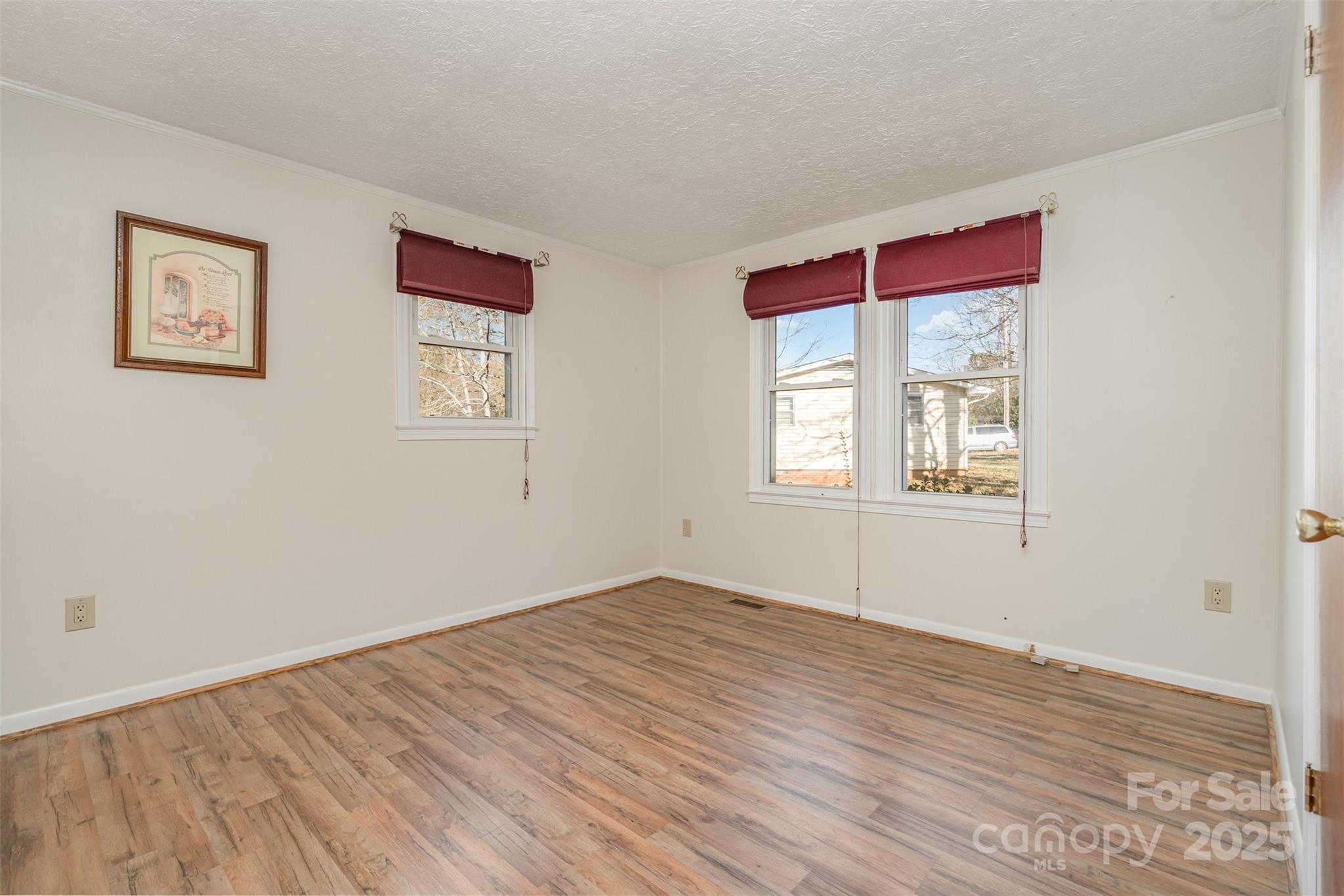 650 Rama Wood Drive Southeast Concord, NC 28025 - Photo 12 of 17 a view of empty room with wooden floor and fan