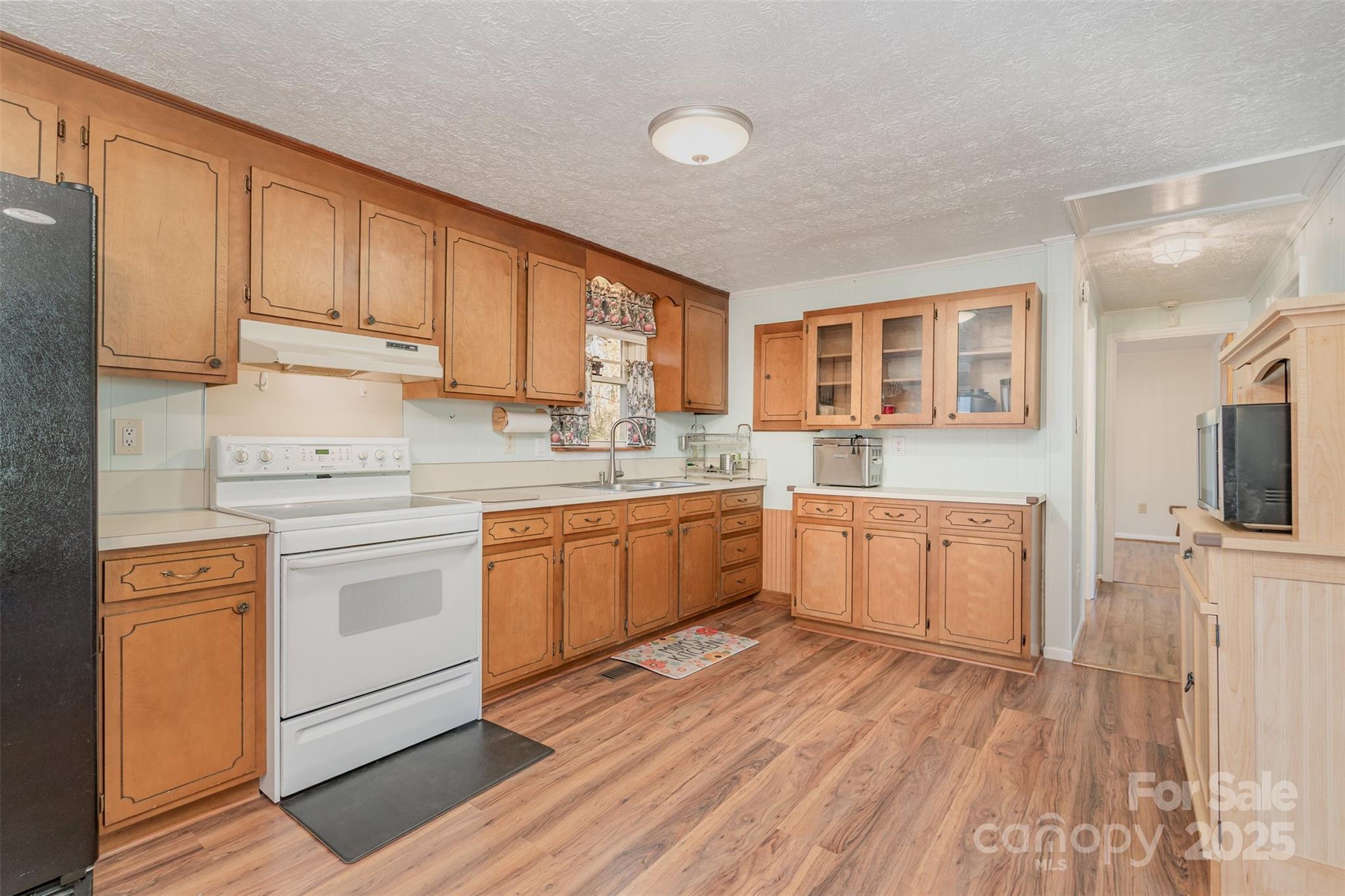 650 Rama Wood Drive Southeast Concord, NC 28025 - Photo 7 of 17 a kitchen with a white cabinets stove and sink