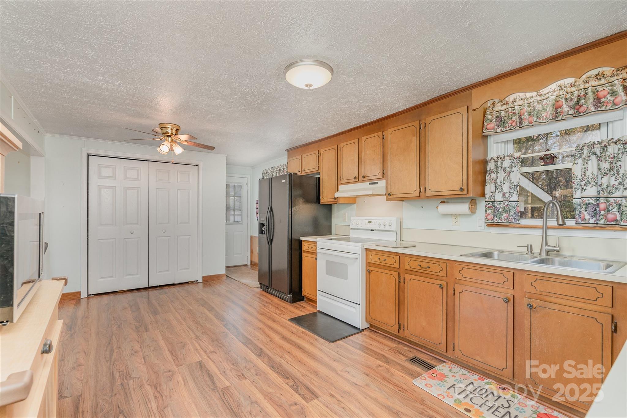 650 Rama Wood Drive Southeast Concord, NC 28025 - Photo 8 of 17 a kitchen with stainless steel appliances granite countertop a sink cabinets and wooden floor
