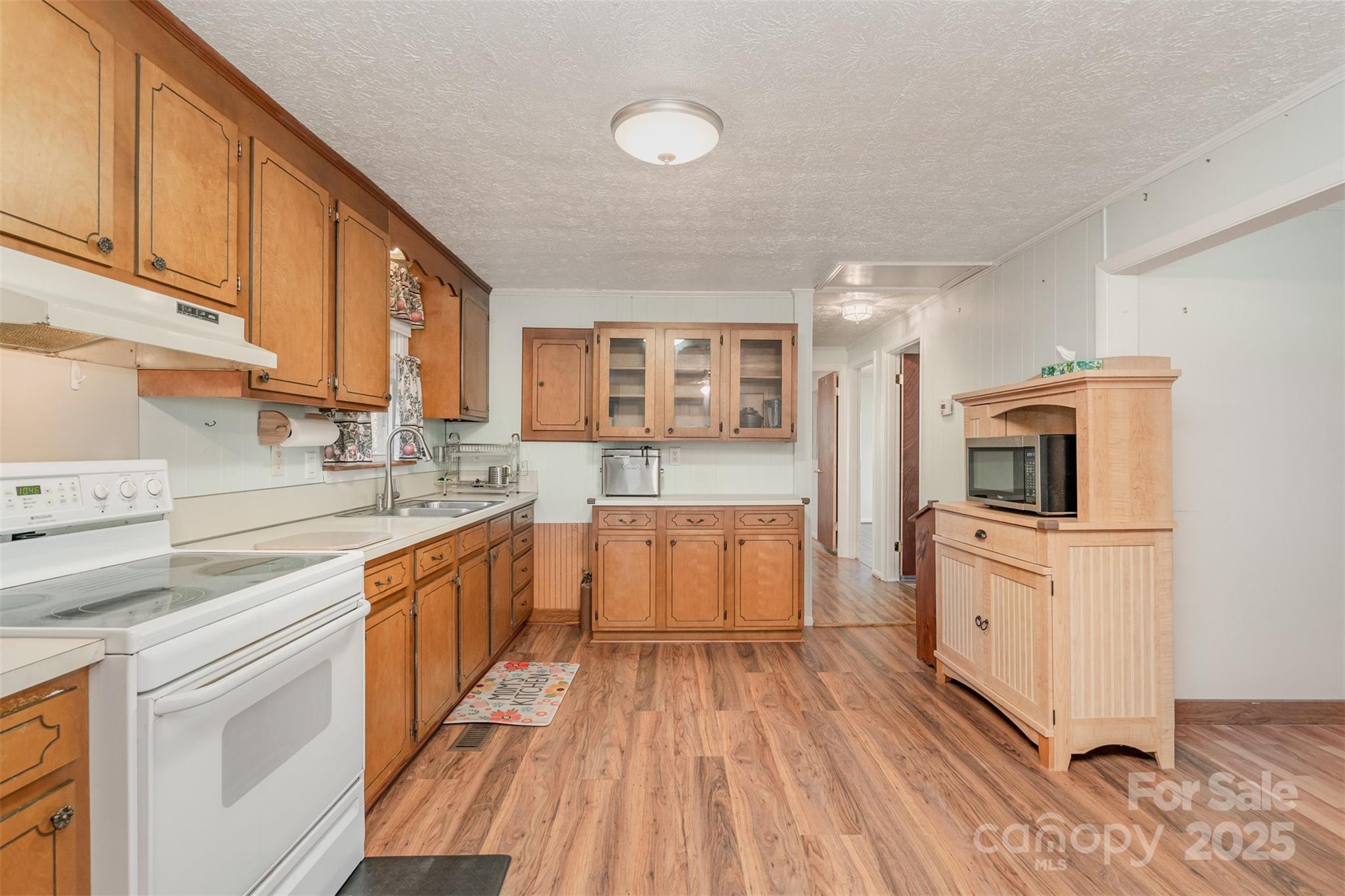 650 Rama Wood Drive Southeast Concord, NC 28025 - Photo 9 of 17 a large kitchen with a lot of counter space and wooden floor