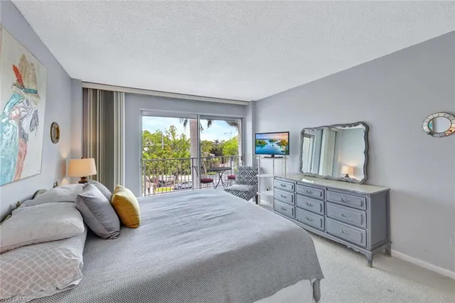 a bedroom with a bed and large window