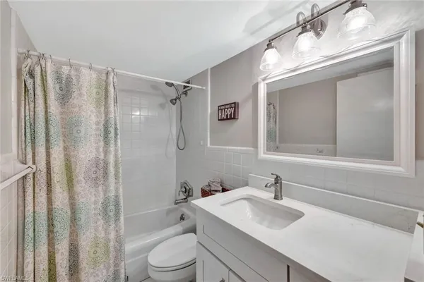 a bathroom with a sink toilet tub and shower