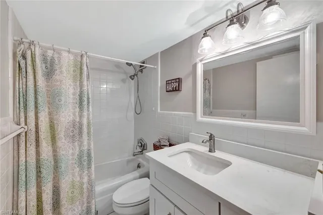 a bathroom with a sink toilet tub and shower