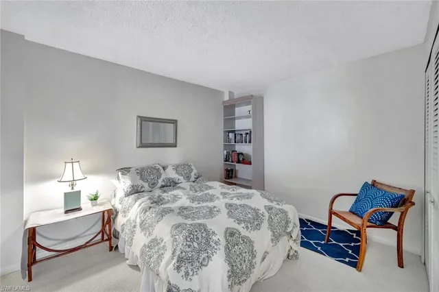 a bedroom with a bed and a chair