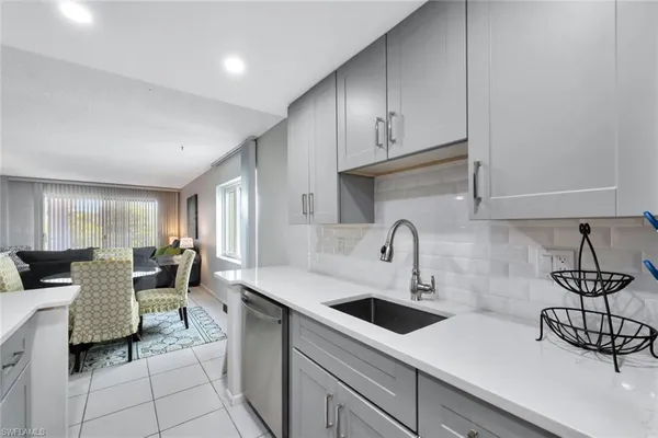 a kitchen with a sink cabinets and window