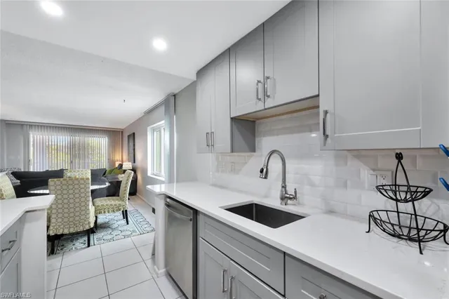a kitchen with a sink cabinets and window