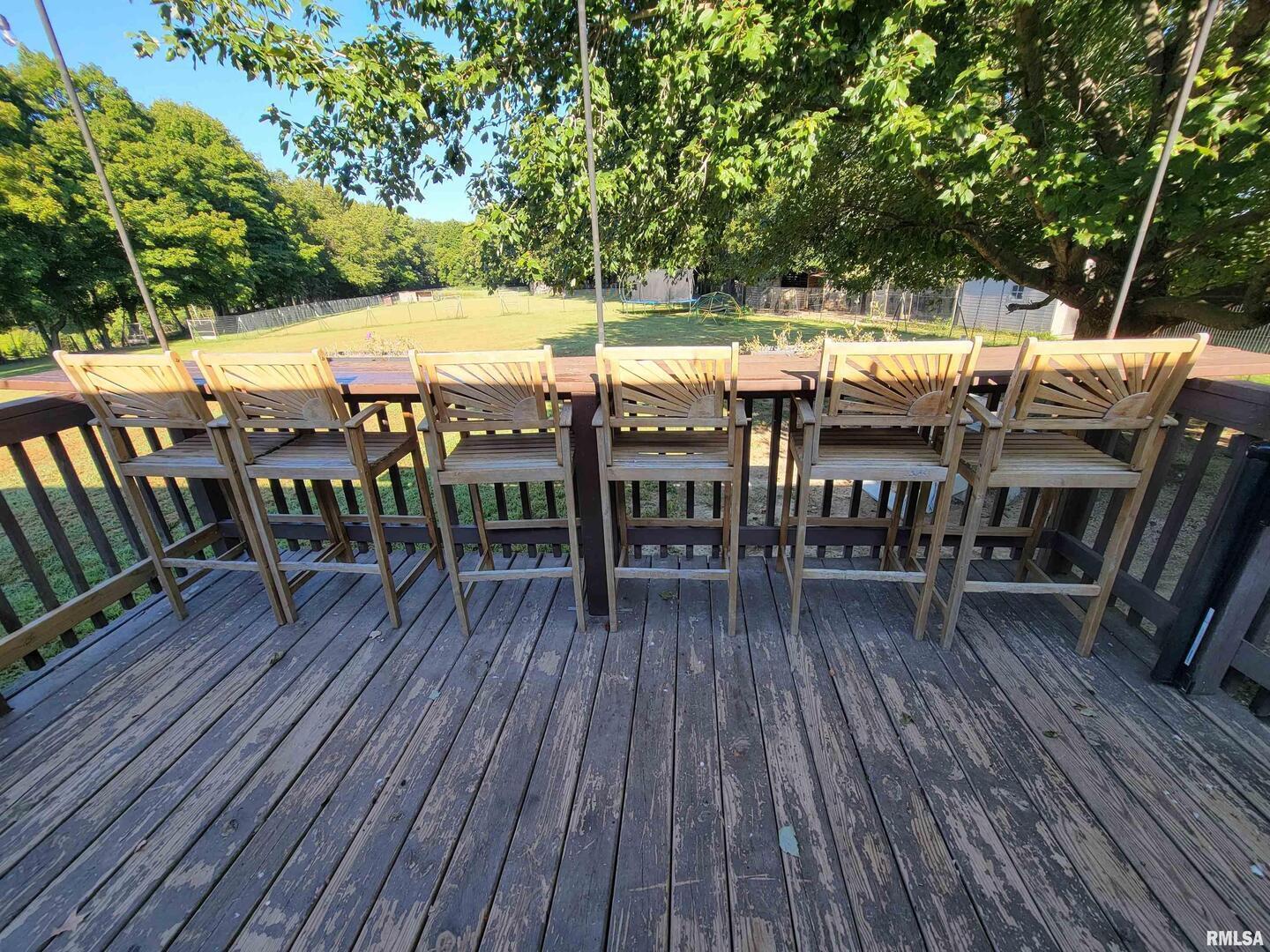 2517 Cherrybark Lane Flora, IL 62839 - Photo 15 of 99 a view of a patio with table and chairs with wooden floor and fence