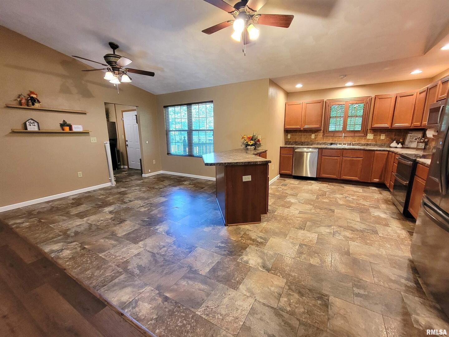 2517 Cherrybark Lane Flora, IL 62839 - Photo 33 of 99 a large kitchen with cabinets and stainless steel appliances