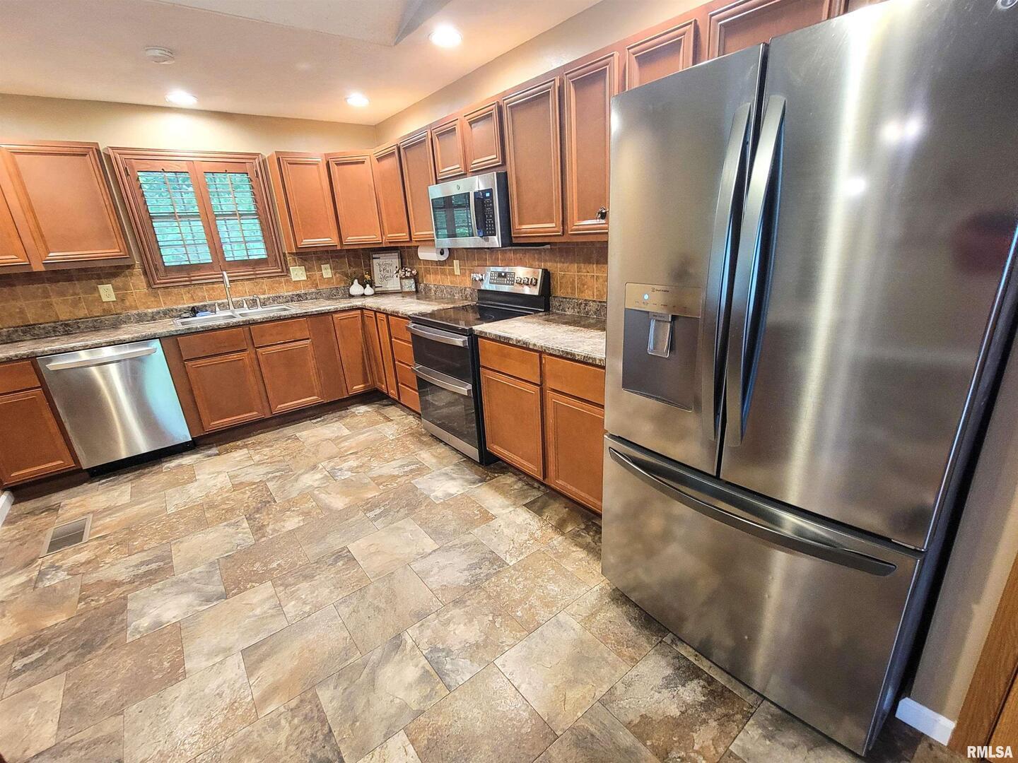 2517 Cherrybark Lane Flora, IL 62839 - Photo 52 of 99 a kitchen with stainless steel appliances granite countertop a refrigerator sink and cabinets
