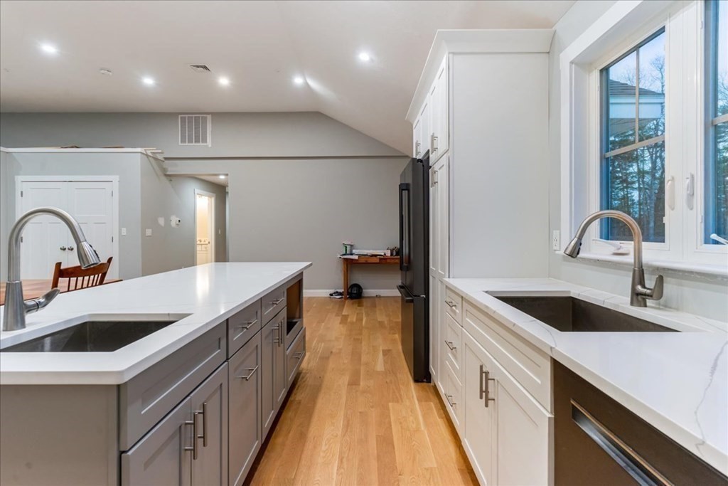 185 Kimball Road Amesbury, MA 01913 - Photo 11 of 24 a kitchen with kitchen island a sink a stove and a refrigerator