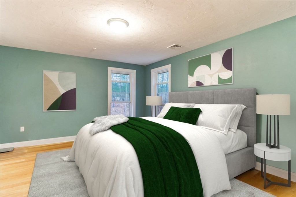 185 Kimball Road Amesbury, MA 01913 - Photo 12 of 24 a bedroom with a bed and painting on the wall