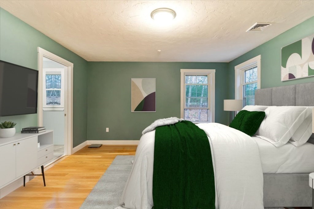 185 Kimball Road Amesbury, MA 01913 - Photo 13 of 24 a bedroom with a bed and a flat screen tv