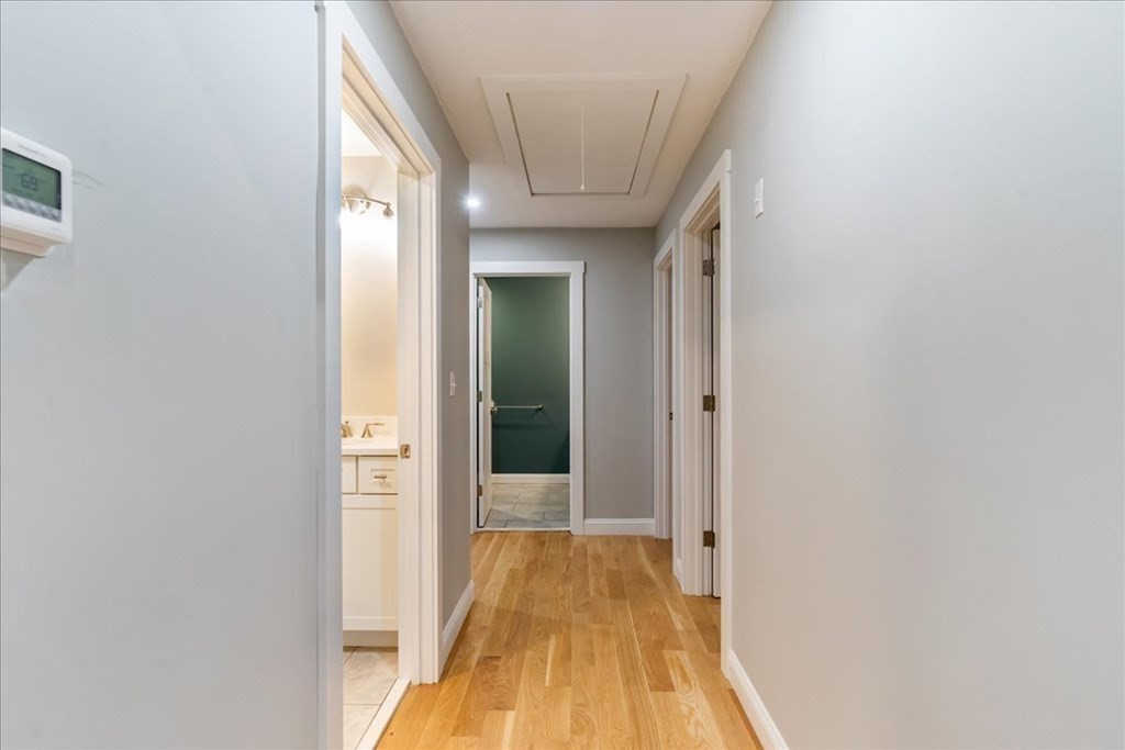 185 Kimball Road Amesbury, MA 01913 - Photo 17 of 24 a view of a hallway with wooden floor and a bathroom