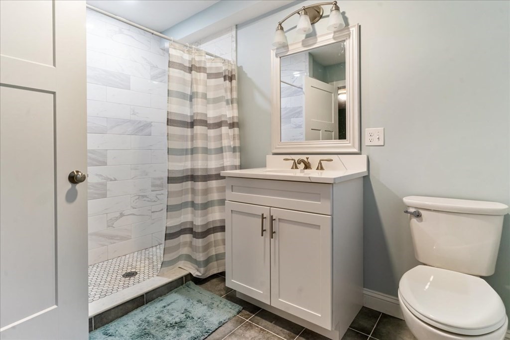 185 Kimball Road Amesbury, MA 01913 - Photo 20 of 24 a bathroom with a sink a toilet and shower