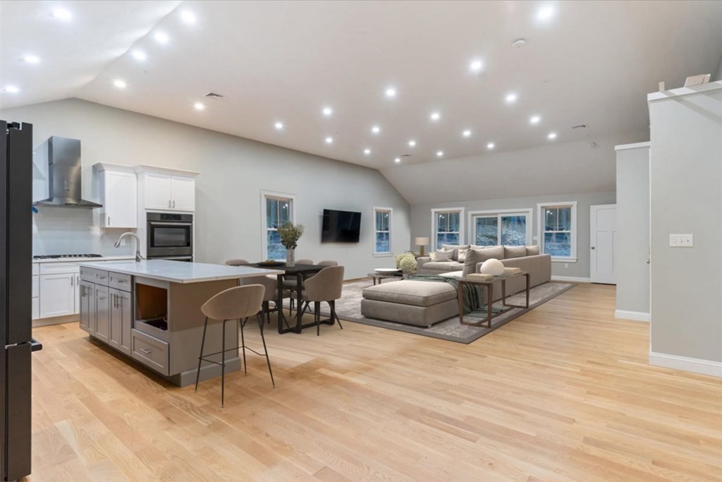 185 Kimball Road Amesbury, MA 01913 - Photo 8 of 24 a living room with furniture a flat screen tv and kitchen view