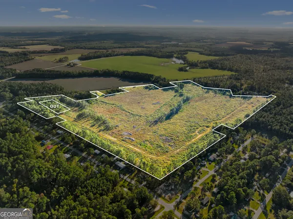 an aerial view of a house with swimming pool lake and mountain view